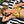 Girl wearing a yellow and black bikini top with alternating cat and dog print 