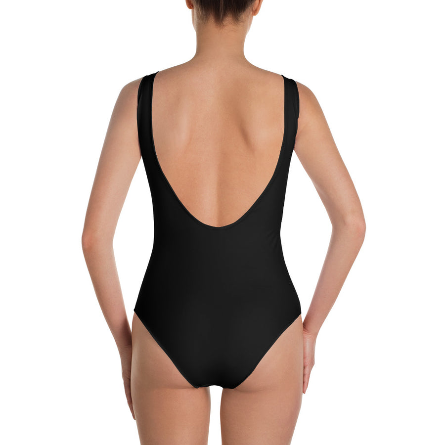 The back of a girl wearing a black full piece swimsuit
